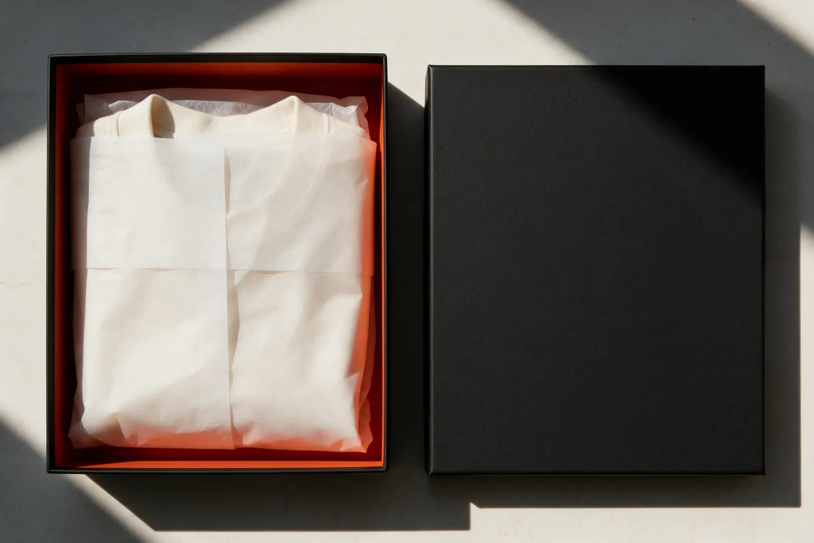 An open black rigid box with an orange interior beside its lid, which carries the WAVELINE lockup.